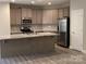 Well-lit kitchen features stainless steel appliances and granite countertops for modern cooking at 5126 Rocky River Crossing Rd, Harrisburg, NC 28075