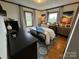 Cozy bedroom featuring hardwood floors, bright windows, comfortable bedding, and stylish decor at 5373 Nc Hwy 16 N Hwy, Taylorsville, NC 28681