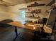Bright home office with natural wood desk, shelving, and white shiplap walls, creating a comfortable workspace at 5373 Nc Hwy 16 N Hwy, Taylorsville, NC 28681