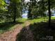 Scenic view of a grassy path leading through a wooded area, creating a tranquil and natural setting at 5373 Nc Hwy 16 N Hwy, Taylorsville, NC 28681