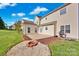 A well-maintained backyard with patio, fire pit, and lush green lawn at 6115 The Meadows Ln, Harrisburg, NC 28075