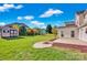 A spacious backyard with a patio, firepit, storage shed and green grass, perfect for outdoor activities at 6115 The Meadows Ln, Harrisburg, NC 28075
