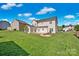Lush backyard featuring a well-manicured lawn and a charming patio area for outdoor relaxation at 6115 The Meadows Ln, Harrisburg, NC 28075