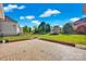 A spacious backyard with green grass, a patio area, and a storage shed surrounded by a wooden fence at 6115 The Meadows Ln, Harrisburg, NC 28075
