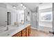 Bright bathroom with a double vanity, a bathtub, and a separate shower at 6115 The Meadows Ln, Harrisburg, NC 28075