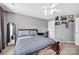 This cozy bedroom features a ceiling fan, shelving, and comfortable bed at 6115 The Meadows Ln, Harrisburg, NC 28075