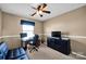 Bedroom with desk, futon, ceiling fan and neutral colored walls at 6115 The Meadows Ln, Harrisburg, NC 28075