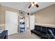 Bedroom with futon, ceiling fan, and decorative shelving at 6115 The Meadows Ln, Harrisburg, NC 28075