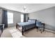 This bedroom is bright with natural light, with a ceiling fan and simple decor at 6115 The Meadows Ln, Harrisburg, NC 28075