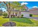 A beautiful two-story home with manicured lawn and mature trees enhancing the curb appeal at 6115 The Meadows Ln, Harrisburg, NC 28075