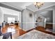 Open hallway with hardwood floors and views of the office, stairs and dining area at 6115 The Meadows Ln, Harrisburg, NC 28075