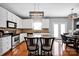 Kitchen featuring an island with granite countertops and a pendant light at 6115 The Meadows Ln, Harrisburg, NC 28075