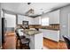 Beautiful kitchen with white cabinetry, island seating, and stainless steel appliances at 6115 The Meadows Ln, Harrisburg, NC 28075