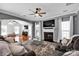 Spacious living room features a fireplace, ceiling fan, and natural light at 6115 The Meadows Ln, Harrisburg, NC 28075