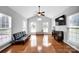 Living room with vaulted ceiling, hardwood floors, and plenty of natural light at 6115 The Meadows Ln, Harrisburg, NC 28075