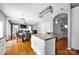 Open concept living space with kitchen island and fireplace at 6115 The Meadows Ln, Harrisburg, NC 28075