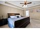 Cozy main bedroom featuring a tray ceiling, ceiling fan, and neutral decor at 6115 The Meadows Ln, Harrisburg, NC 28075