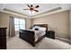 Comfortable main bedroom with a large window, ceiling fan, and neutral decor at 6115 The Meadows Ln, Harrisburg, NC 28075