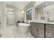 Luxurious bathroom with a standalone tub, dual vanities, and marble flooring for a spa-like experience and aesthetic appeal at 6654 Maple Spring Ct, Denver, NC 28037