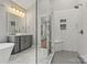 Bathroom with a large vanity, a stylish mirror, and a glass-enclosed shower that exudes modern elegance and functionality at 6654 Maple Spring Ct, Denver, NC 28037