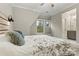 Bedroom featuring a decorative headboard, window seat, and a view into the bathroom at 6654 Maple Spring Ct, Denver, NC 28037