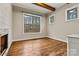 Bedroom featuring a fireplace, hardwood floors, and large windows at 6654 Maple Spring Ct, Denver, NC 28037