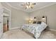 Comfortable bedroom with a unique headboard and a view to an open doorway at 6654 Maple Spring Ct, Denver, NC 28037