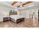 Bedroom showcasing hardwood floors, exposed wooden beams, and a ceiling fan offering a rustic, yet modern, aesthetic at 6654 Maple Spring Ct, Denver, NC 28037