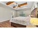Bright bedroom with hardwood floors, exposed wooden beams, a ceiling fan, and a window for natural light and scenic views at 6654 Maple Spring Ct, Denver, NC 28037