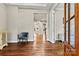 Open foyer with hardwood flooring, chair rail detail, and a glimpse of the staircase at 6654 Maple Spring Ct, Denver, NC 28037