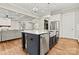 Kitchen island with marble countertop, stainless steel appliances, and open view to the living room at 6654 Maple Spring Ct, Denver, NC 28037