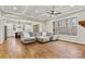 Spacious living room with a coffered ceiling, large windows, and hardwood floors at 6654 Maple Spring Ct, Denver, NC 28037