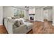 Bright living room showcasing a fireplace, hardwood floors, and a comfortable sectional sofa at 6654 Maple Spring Ct, Denver, NC 28037