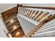 Wooden staircase with white risers and integrated step lighting at 6654 Maple Spring Ct, Denver, NC 28037