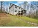 A view of the backyard featuring a well-manicured lawn and a deck on the house at 6654 Maple Spring Ct, Denver, NC 28037