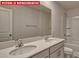 Bathroom showcasing a double sink vanity, large mirror and tub with shower at 7330 Stonehouse Dr, Gastonia, NC 28056