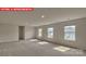 Spacious carpeted bedroom with large windows allowing ample natural light at 7330 Stonehouse Dr, Gastonia, NC 28056