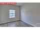 Bright bedroom featuring hardwood floors and natural light from one well-lit window at 7330 Stonehouse Dr, Gastonia, NC 28056