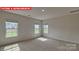 Upstairs bedroom featuring neutral carpet and three windows at 7330 Stonehouse Dr, Gastonia, NC 28056