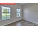 Bright bedroom featuring hardwood floors and natural light from two well-lit windows at 7330 Stonehouse Dr, Gastonia, NC 28056