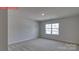 Spacious bedroom with plush neutral carpeting and a window at 7330 Stonehouse Dr, Gastonia, NC 28056