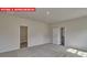 View of a neutral bedroom showcasing the connecting door and plush carpeting at 7330 Stonehouse Dr, Gastonia, NC 28056