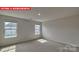 Bright bedroom with neutral carpet and three windows at 7330 Stonehouse Dr, Gastonia, NC 28056