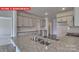 This spacious kitchen features gray cabinets, stainless steel appliances, and a large island with a sink at 7330 Stonehouse Dr, Gastonia, NC 28056