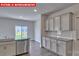 The kitchen features granite countertops, stainless steel appliances, gray cabinets and a sliding glass door at 7330 Stonehouse Dr, Gastonia, NC 28056
