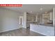 Open floorplan of kitchen and living area featuring hardwood floors and natural light at 7330 Stonehouse Dr, Gastonia, NC 28056