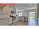 This kitchen features granite countertops, gray cabinets, stainless steel appliances, and a sliding glass door at 7330 Stonehouse Dr, Gastonia, NC 28056