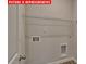 A utility room with washer and dryer hookups and wire rack for storage at 7330 Stonehouse Dr, Gastonia, NC 28056