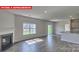 Spacious living room with fireplace, large window, and stylish flooring at 7330 Stonehouse Dr, Gastonia, NC 28056