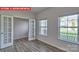 Living room area featuring hardwood floors, open floorplan, double doors and natural light at 7330 Stonehouse Dr, Gastonia, NC 28056